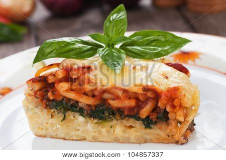 Pasticcio or pastitsio with chard and tomato sauce, italian baked pasta