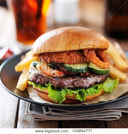 western barbecue hamburger with onion rings and french fries