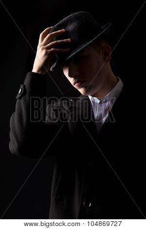 Handsome Mafioso Man Touching Hat In The Dark