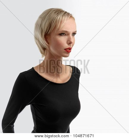 Portrait Of A Beautiful Blonde Woman In A Black Dress.