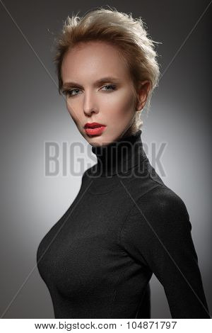Portrait Of A Beautiful Blonde Woman In A Black Sweater.