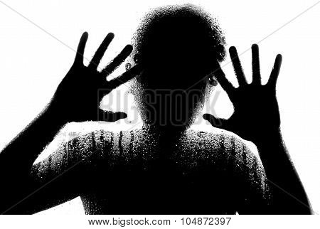 Horror woman behind the matte glass