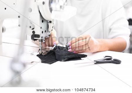 Sewing on a machine.