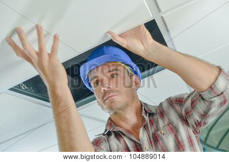 Builder replacing ceiling panel