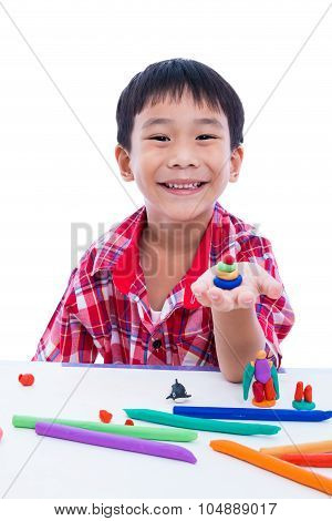 Child Smiling And Show His Works From Clay, On White Background. Strengthen The Imagination