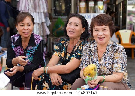 HO CHI MINH VILLE, VIETNAM, FEBRUARY 26, 2015 : A group of friendly vegetable sellers is posing in the street of Chinatown of Ho Chi Minh Ville, (Saigon), Vietnam.