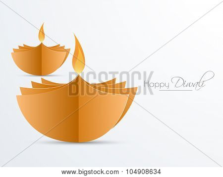Creative illuminated lit lamps made by glossy papers for Indian Festival of Lights, Happy Diwali celebration.