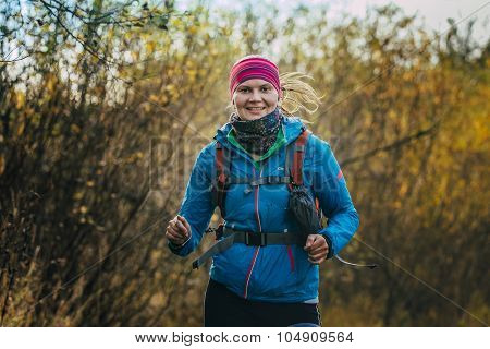 beautiful smiling girl running in autumn forest