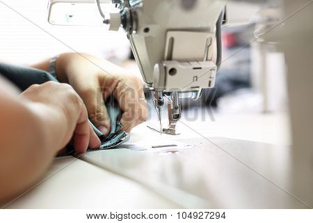 Sewing on a machine.