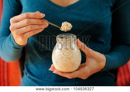 Woman's Slender Hands Holding Glass Jar And Spoon With Overnight Oats Selective Focus