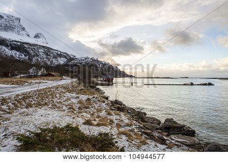 Norwegian landscape with a tiny road along the seaside in a fjord in the winter Nordland Norway