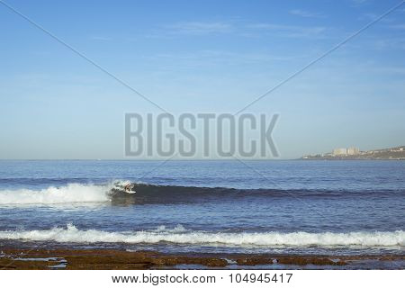 A Man Riding The Waves On The Surf