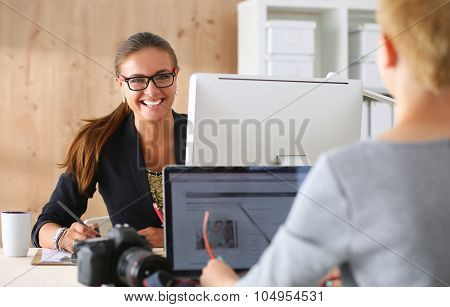 Porttrait of two females working in the office.
