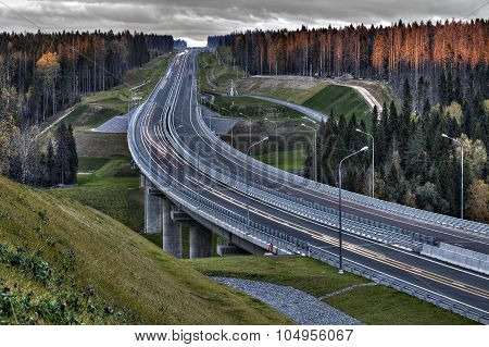 Speed Track In Russia At Sunset, Crosses The Autumn Forest.