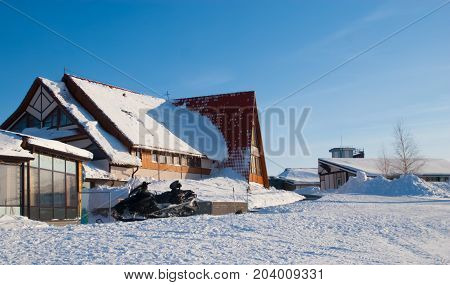 Winter house in ski resort on blue sky