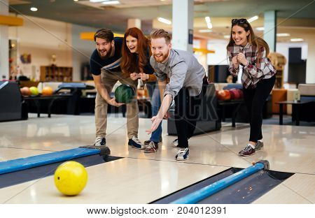Friends having fun while bowling and speding time together