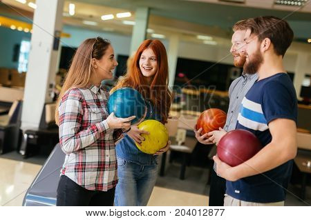 Friends having fun while bowling and speding time together