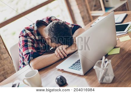 Sweet Dreams At The Work Place. Sleepy Tired Freelancer Is Snoozing At Wooden Desk Top, Coffee Cup A
