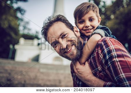 Father with his little cute son outdoors. Having fun and enjoying spending time together.