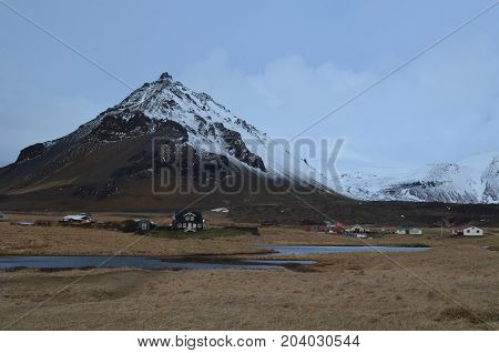 Beautiful look at a village at the base of a mountainin Iceland.