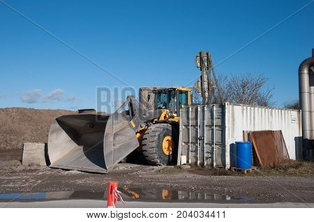 Big Digger hidden behind a container in Vordingborg Denmark