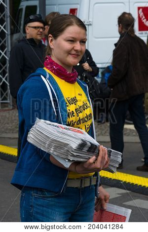 BERLIN - MAY 01 2015: International Labour Day. Distributor of free newspapers.