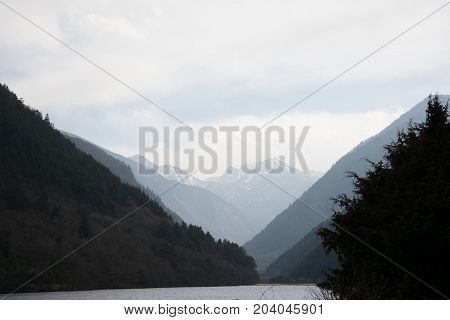 River landscape with mountains. Mountains in the background of a river. Forest mountains in the water