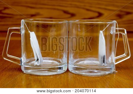 Two cups of tea for morning tea on the balcony tea bag on wooden background brown