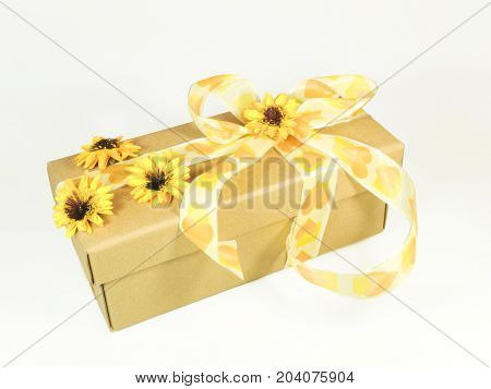 Decorative wrappage of gift box adorned with flowers and bow