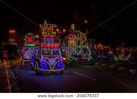 JOGJA, INDONESIA - AUGUST 12, 2O17: A traditional pedicap transport parket at outdoor with colorful and bright lights at night at jogja Yogyakarta Indonesia.