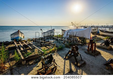 POMORIE BULGARIA - AUGUST 17 2017: Fishing boats on the shore. Seaport of the seaside town of Pomorie.