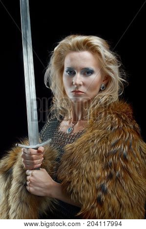 Valkyrie. Viking girl  posing performance , with sword