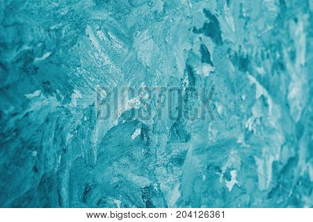 abstract turquoise frosty background on the winter glass