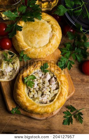 Round meat pie with vegetables and spices on a wooden background. Selective focus.