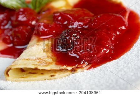 Pancakes with strawberry jam.  closeu p   meal