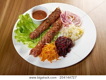 caucasian Luleh kebab with vegetable , close up