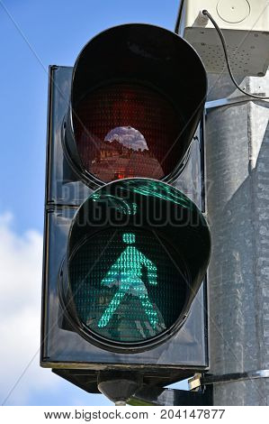 Green traffic light at the pedestrian road cossing