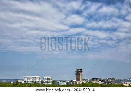 View on Olsany Jewish Cemetary covered by dense stand of trees and city architecture at the background Prague Czech Republic Prague 3 area