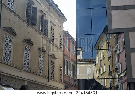 Parma (Emilia Romagna Italy): old and modern buildings in the Cesare Battisti square. Reflections.