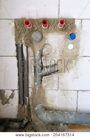 Installation of a water pipes and drainage tubes in new house construction. New water piping installation.