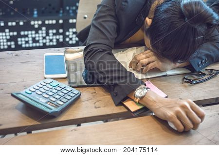 Businesswoman is sleeping on the desk in office after hard work.