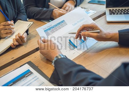 Business consultants is checking and analyzing sales figures to plan business strategies.