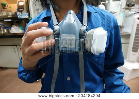 Multi-purpose respirator half mask for toxic gas protection.The man prepare to wear Multi-purpose respirator half mask.