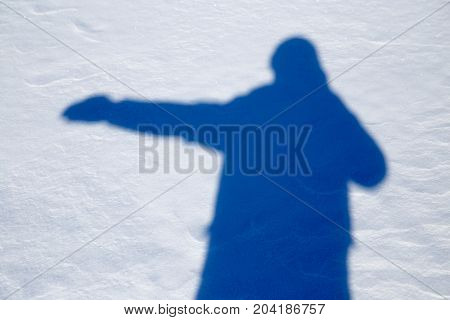shadow of a man in the snow