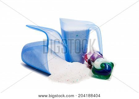 Washing powder in a measuring cup isolated on white background