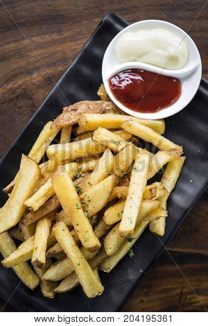 french fries chips side snack with diping sauces on wooden table