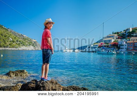 The boy looks at the Assos on the Island of Kefalonia in Greece.