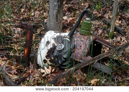 Scary authentic Russian gas mask with breathing hose abandoned in woods