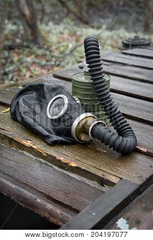 Scary authentic Russian gas mask with breathing hose abandoned in woods