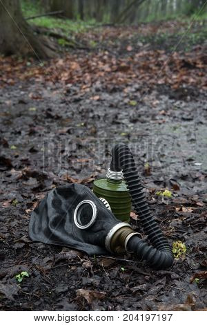 Scary authentic Russian gas mask with breathing hose abandoned in woods